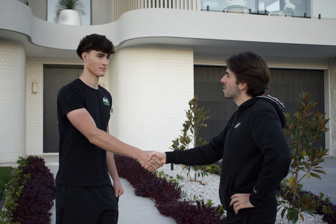 Max from To The Max Lawns shaking hands with a happy customer outside their home